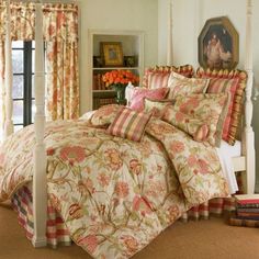 a bedroom with a bed covered in a floral comforter and matching pillow shampoos