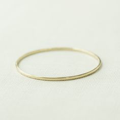 The Decade – Yearly Company Minimalist 14k Gold Hoop Bangle, Minimalist Polished Bangle, Minimalist Gold Hoop Bracelet, Stackable Dainty 14k Gold Bangle, Minimalist Yellow Gold Hoop Bracelet, Dainty Stackable 14k Gold Bangle, Modern 14k Gold Hoop Bangle, Wedding Bangle With Polished Finish, Yellow Gold Bangle With Polished Finish For Wedding