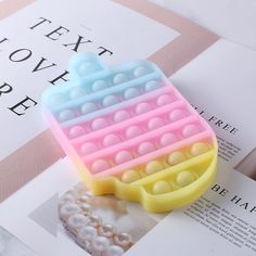 a close up of a cell phone case on top of a book with pearls in it