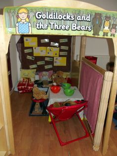 there is a child's play area with toys and books on the table in front of it