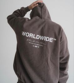 a person wearing a hoodie with the word world wide on it's back