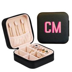 an open black case with rings and jewelry inside it that says cm on the front