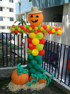 an inflatable halloween decoration with balloons and a jack - o'- lantern