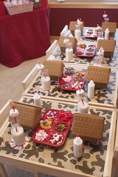 the table is set up with candy and marshmallows