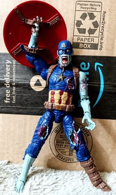 the action figure is posed on top of a cardboard box