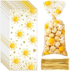 a bag of yellow candies next to a package of gold foiled strawberries