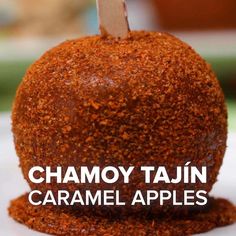 a close up of an apple on a plate with the words chamoy tatin caramel apples