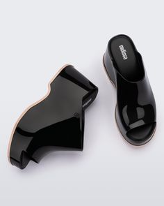 Throwback style meets current trends—that’s just how the Patty rolls. Lightweight and streamlined with a wide strap and a peep toe, these platform mules are true attention seekers, and the contrasting sole detail amps up the cool factor. Made from our revolutionary Melflex® PVC plastic, you enjoy more flexibility and comfort. Plus, they’re 100% recyclable. Trendy Black Open Heel Platform Slippers, Trendy Black Platform Slippers With Open Heel, Trendy Black High Heel Platform Slippers, Casual Black Open Heel Platform Slippers, Chic Black High Heel Platform Slippers, Trendy Mules With Removable Insole, Spring Black Open Heel Platform Slippers, Black Open Heel Platform Slippers For Spring, Chic Black Slip-on Platform Slippers