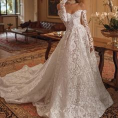 a woman in a wedding dress standing on a rug