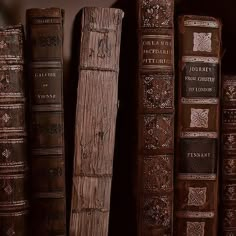 old books are lined up on a shelf