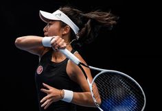 a woman swinging a tennis racquet at a ball