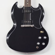 an electric guitar hanging on the wall with it's neck and fretset