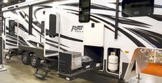 an rv parked in a showroom next to other vehicles