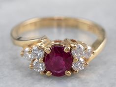 Timeless simplicity! This deeply colored red ruby sits in a simple four-prong setting, crafted of yellow gold. The polished gold really lets the color of the ruby stand out, and the lovely diamond accents add amazing sparkle and elegance to the ring! This could make a great engagement ring, or just as a ring for any occasion! Metal: 14K Yellow Gold Gem: Ruby .74 Carats Gem Measurements: 5.7 x 4.8 mm, Oval Accents: 6 Diamonds totaling .36 Carats, G in Color, VS in Clarity Ring Size: 6 Marks: ".36 Ruby Ring Simple, Ruby Wedding Ring Set, Ruby Ring Designs, Antique Ruby Ring, Gold Ruby Ring, Yellow Gold Sapphire Ring, Ruby Ring Vintage, Timeless Simplicity, Engagement Ring Yellow Gold