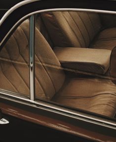 the interior of an old car with leather upholster and seat cushions on it