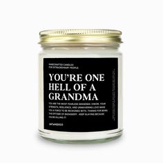 a white candle with the words you're one hell of a grandma on it