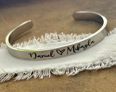 This listing features ONE stainless steel silver, gold, or rose gold cuff bracelet for your daughter or daughter in law.  The outside of the bracelet will come with the bride and groom's names separated with a heart symbol, or a monogram in the script font shown, along with a date on one end and a heart or Love infinity symbol on the other end. The inside of the bracelet will come with a message, personalized if desired.  -->Today God blessed my son with a wife, and me a daughter and friend for Personalized Stainless Steel Jewelry With Custom Text, Minimalist Stainless Steel Bangle For Anniversary, Minimalist Stainless Steel Anniversary Bangle, Personalized Stainless Steel Bangle Name Bracelet, Personalized Stainless Steel Name Bangle, Customized Stainless Steel Name Bracelet For Anniversary, Personalized Stainless Steel Bracelets For Anniversary, Personalized Rose Gold Bracelets For Wedding, Personalized Rose Gold Wedding Bracelets