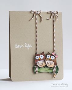 two owls sitting on top of a tree branch with the words love life written above them