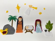 felt nativity scene with palm tree, star, and birth jesus on white background