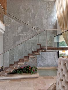 a living room filled with furniture next to a stair case