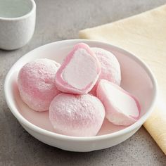 pink marshmallows in a white bowl on a table