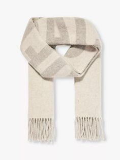 "Translating simply to """"the scarf"""", the L'echarpe is the latest Jacquemus piece to drop – and, no doubt, it's captured everyone's attention. An oversized, rectangular style woven from pure virgin wool, it's uber-soft and cosy to lock out the trans-seasonal cold and comes with the brand's name in bold lettering. If we weren't impressed with Creative Director Simon Porte Jacquemus before, we certainly are now." Simon Porte Jacquemus, Wool Knit Scarf, Lock Out, Bold Lettering, Bridal Shoes Flats, Baby Changing Bags, Bag Boys, Slippers For Girls, Jacquard Knit