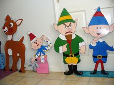 three paper cut outs of cartoon characters standing in front of a door