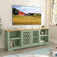 a living room scene with focus on the entertainment center and red barn in the background