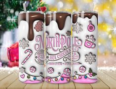 three white and pink christmas candles with chocolate frosting on the top, surrounded by snowflakes