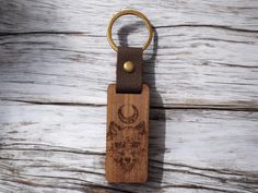 a wooden keychain with an animal design on it