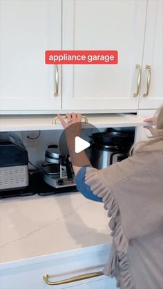 a woman is opening the oven door to check out her new appliance garage