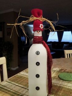 a snowman made out of plastic bottle sitting on top of a table