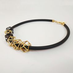 "An elegant black and gold geometric necklace on black silicon cord. Unique geometric elements and a toggle clasp. This necklace will upgrade any outfit! You can wear it with a plain white t-shirt and your favorite pair of jeans all day long at work, or with a small black dress on the evening when you celebrate life! Find out which way you like it the best! * * * * * * * * * * * Materials: 0.24\"/6m\"m thick black silicon cord gold plated pewter gold plated toggle clasp & elements Toggle cla Black Minimalist Jewelry For Everyday, Black Geometric Jewelry, Geometric Black Necklace For Gift, Black Geometric Necklace For Gift, Adjustable Geometric Black Jewelry, Adjustable Black Geometric Jewelry, Modern Black Geometric Necklace, Gold Geometric Necklace, Plain White T Shirt