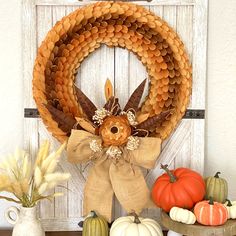 a wreath with an eagle on it sitting next to other fall decorations