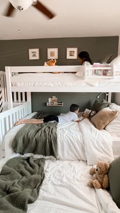 two children are laying in bunk beds with their stuffed animals on the bottom bunk bed