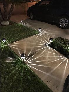 some lights that are on the ground in front of a car