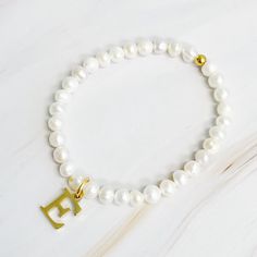 Adorn your wrist with a stylish Freshwater Pearl Initial Charm Bracelet. Featuring freshwater pearls and a clean font initial charm, this bracelet provides both timeless elegance and personalization. It makes the perfect gift for yourself or your loved ones and is suitable for everyday wear or special occasions. Stack it with other bracelets for a stunning layered look. Dimensions: approximately 6.5" before stretch Genuine freshwater pearls 18k gold plated stainless steel initial charm with wate Clean Font, Initial Charm Bracelet, Hair Setting, Pearl Collection, Moissanite Jewelry, Initial Charm, Steel Jewelry, Layered Look, Stainless Steel Jewelry