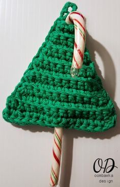 a green crocheted christmas tree ornament with candy cane