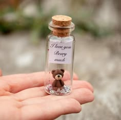 a tiny teddy bear in a bottle with a message on it's label that says i love you berry much