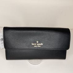 Kate Spade Madison Travel. Wristlet/ Clutch/ Wallet New With Tags Saffiano Leather Color - Black Gold Tone Hardware Metal Monogram Rear Zip Pocket Detachable Wristlet Strap With 6" Drop Snap Closure 12 Card Slots 2 Cash Slots Passport Slot Zip Pocket Really Beautiful! Measures: 8.25" X 4.75" X 1" Black Clutch With Magnetic Closure For Travel, Black Bifold Clutch For Travel, Kate Spade Black Rectangular Wallet, Rectangular Kate Spade Clutch For Travel, Black Travel Wallet With Magnetic Closure, Black Wallet With Magnetic Closure For Travel, Formal Kate Spade Clutch, Kate Spade Rectangular Travel Clutch, Kate Spade Rectangular Clutch For Travel