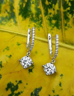 2.0Ct Round Cut Moissanite Hoop Earrings Women Wedding earring Dangle & Drop Earring 14k White Gold Anniversary Gift Birthday Gift Mom Gift.  🖤 Item Information ◆ Metal:  14k White Gold ◆ Ring Size: 4 to 12 USA All Size available ◆ Main Stone:  6mm Round Cut Moissanite ◆ Side Stone: 1.2mm Round Cut Simulated Diamond ◆ Moissanite Color: DEF Near Colorless ◆ Main Stone Creation: Lab-Created ◆ Stone Clarity: VVS1 ◆ Setting: Prong Setting ◆ Style: Hoop  ◆ Cut: Excellent ◆ Polish: Excellent ◆ Center Gift Hoop Earrings With Halo Design And Round Cut, Halo Design Hoop Earrings Gift, Hoop Earrings With Halo Design For Gift, Gift Hoop Earrings With Halo Design, Dangle Hoop Earrings With Halo Design In Cubic Zirconia, Fine Jewelry Dangle Hoop Earrings With Halo Design, Diamond Brilliant Cut Dangle Hoop Earrings, Diamond Hoop Earrings With Brilliant Cut Dangle, White Gold Dangle Hoop Earrings With Brilliant Cut