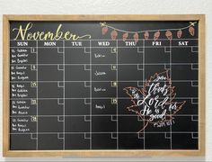 a chalkboard calendar is hanging on the wall