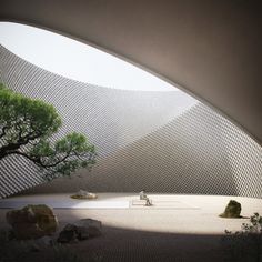 a person sitting on a bench in the middle of a courtyard with trees and rocks