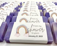 purple soaps with rainbow designs on them are for someone's shower or birthday party