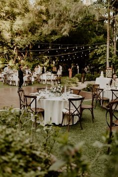 an outdoor wedding reception set up with tables and chairs