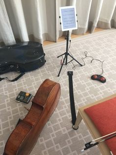 a guitar case sitting on top of a floor next to other musical instruments