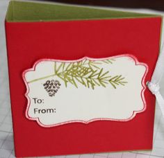 a red and green christmas card with the words to from written on it in white lettering