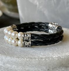 Beautiful Braided Black Leather Sterling Silver Natural Pearl Vintage Bracelet See pictures next to ruler for scale See link below for matching necklace https://www.etsy.com/listing/981075566/beautiful-braided-black-leather-sterling?ref=shop_home_active_1&frs=1 Elegant Double Band Leather Bracelet As Gift, Elegant Handmade Adjustable Leather Bracelet, Handmade Elegant Leather Bracelet, Elegant Handmade Leather Bracelet, Elegant Handmade Double Band Jewelry, Elegant Adjustable Leather Bracelet For Anniversary, Elegant Round Adjustable Leather Bracelet, Elegant Handmade Black Leather Bracelet, Elegant Handmade Black Wrap Bracelet