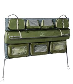 a green and gray hanging organizer with four bags on it's sides, one in the middle