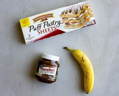 a banana, nut butter and pastry sitting on top of a table